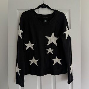Black sweater with white stars. Size large.